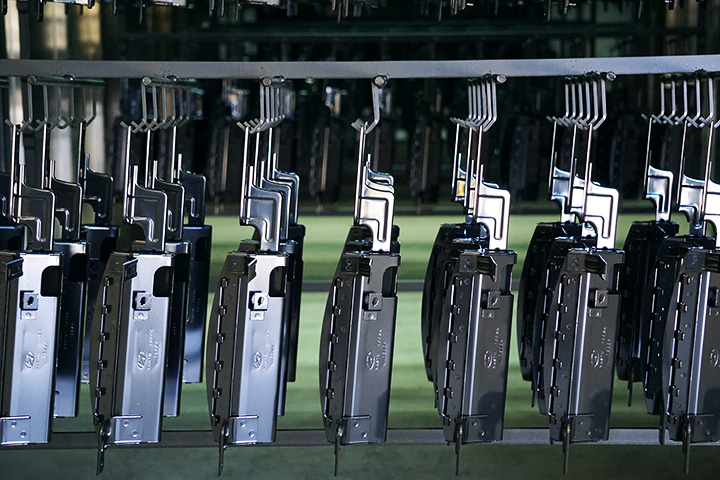 Rows of coated WPI components suspended on the production line